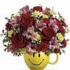 Mixed flower bouquet in a yellow smiley-face mug