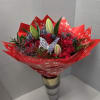 Red rose bouquet with lily buds in a gold vase