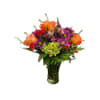 Mixed bouquet of orange roses, purple daisies, and red flowers in a glass vase