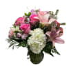 Pink roses and lilies with white hydrangea in a glass vase