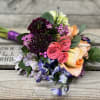 Mixed bouquet with pink and peach roses and purple flowers
