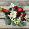 Bouquet of red roses and white flowers with eucalyptus