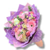 Bouquet of pink and purple flowers wrapped in lavender paper