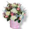 Pink and white rose bouquet in a pink hatbox with a ribbon