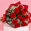 Bouquet of red roses with white baby's breath in red wrap