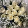 Bouquet of cream roses with white baby's breath and blue spikes