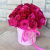Bouquet of hot pink roses in a pink hat box with ribbon