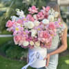 Large pink and white bouquet in a white hat box with ribbon
