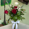 Red roses in a glass vase with a white ribbon and Mother's Day card
