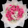 Bouquet of bright pink roses with white baby's breath in pale wrapping
