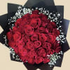 Bouquet of red roses with white baby's breath in black wrap