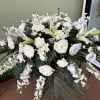 A soft and elegant casket spray designed to honor a life with