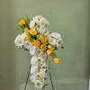 A dignified standing spray shaped like a cross, crafted to offer comfort