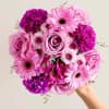 Pink and purple bouquet with roses, gerbera daisies, and carnations