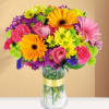 Colorful bouquet of mixed flowers in a clear glass vase