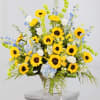 Basket arrangement with yellow sunflowers, white roses, and blue flowers