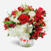 Red roses and white hydrangeas in a clear glass vase