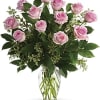 Pink roses arranged in a clear glass vase