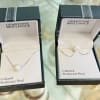 Two pearl necklaces in open jewelry boxes