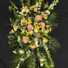 Tall floral standing spray with pink, yellow, and white blooms
