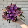 Pink and purple bouquet with a large ribbon bow