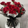 Bouquet of red roses and carnations wrapped in black and white paper