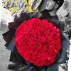 Large bouquet of red roses wrapped in black paper