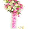 Pink and white floral cross arrangement with roses and lilies