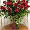 Bouquet of red roses with baby's breath in a vase