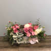 Pink and white rose arrangement in a low rectangular box with a ribbon