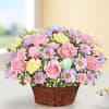 Basket of pink roses, purple daisies, and pastel carnations