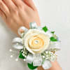 Cream rose wrist corsage with silver ribbon and baby's breath
