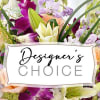 Mixed bouquet of purple, white, and peach flowers with a Designer's Choice sign