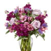 Bouquet of pink and purple flowers in a clear glass vase