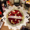 Bouquet of red and white roses with baby's breath and decorative wrap
