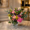 Mixed pink and purple bouquet in a clear glass vase