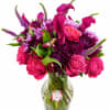 Pink and purple bouquet with roses, calla lilies, and chrysanthemums in a glass vase