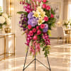 Tall standing floral spray with pink roses, lilies, orchids, and hydrangeas