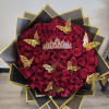 Heart-shaped bouquet of red roses with gold butterfly decorations and a tiara