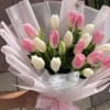 Bouquet of pink and white tulips wrapped in pale pink paper