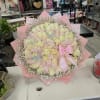 Large bouquet of pale pink and cream roses with a pink ribbon