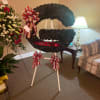Football-shaped floral tribute on an easel with red-and-white ribbons