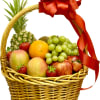 Fruit basket with pineapple, grapes, apples, oranges, mangoes, and strawberries