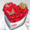 Heart-shaped box of red roses with butterfly and crown decorations