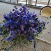 Low bouquet of blue and purple flowers on a table