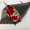 Bouquet of red roses with baby's breath wrapped in black paper