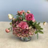 A compact garden-style arrangement in soft pinks, peaches and fresh green, Meadow