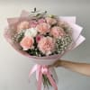 Pink and white mixed bouquet wrapped in pink paper with a ribbon