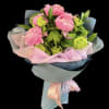 Pink peony bouquet wrapped in pastel paper with ribbon