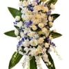 White and pale yellow floral spray with blue accents and large green leaves